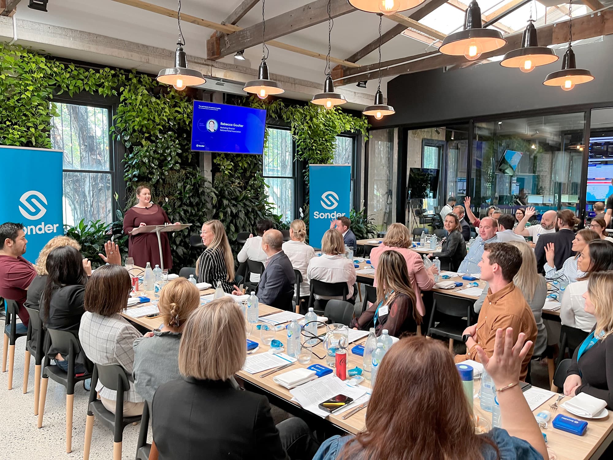 Bec speaking to an audience at a Sonder event