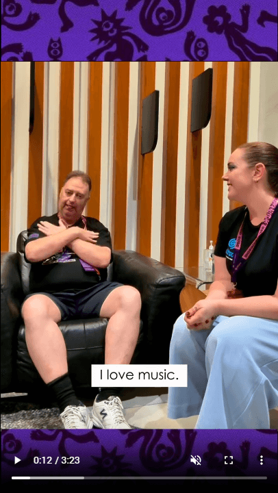Bec interviewing Hamish Christie, who is signing, with on-screen English captions
